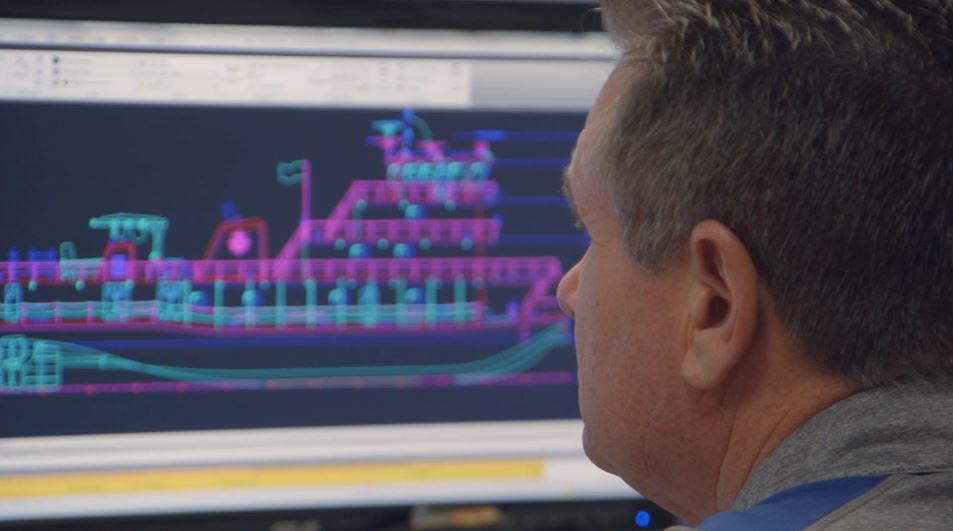 Man monitoring boat on computer screen