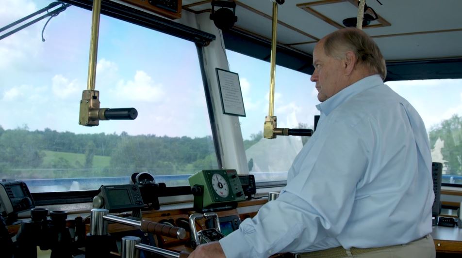 Man steering a boat