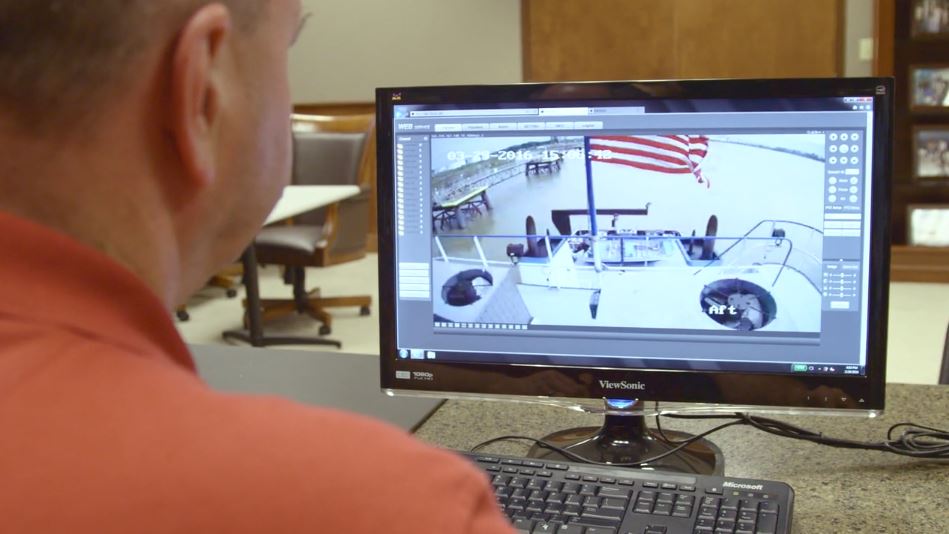 Florida Marine employee viewing boat camera on computer screen