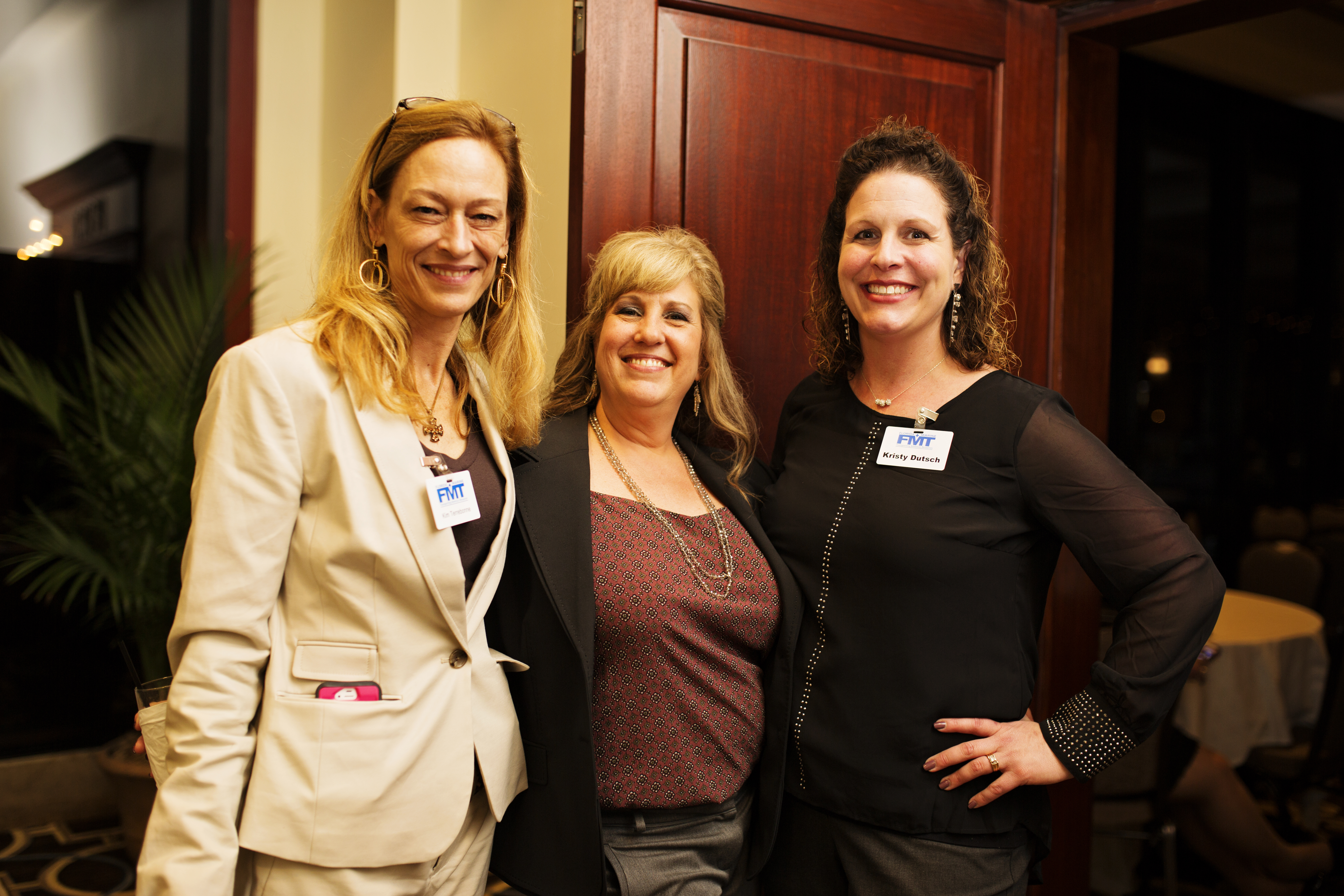 Photo of three Florida Marine Transporters employees at charity event