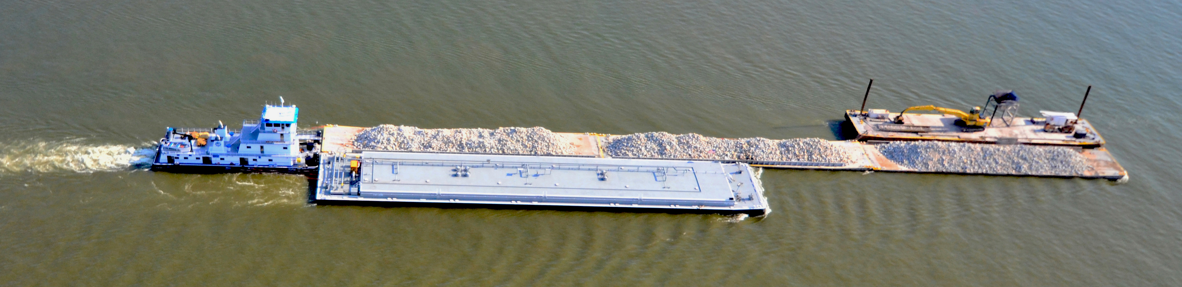 Towboat transporting 3 different barges