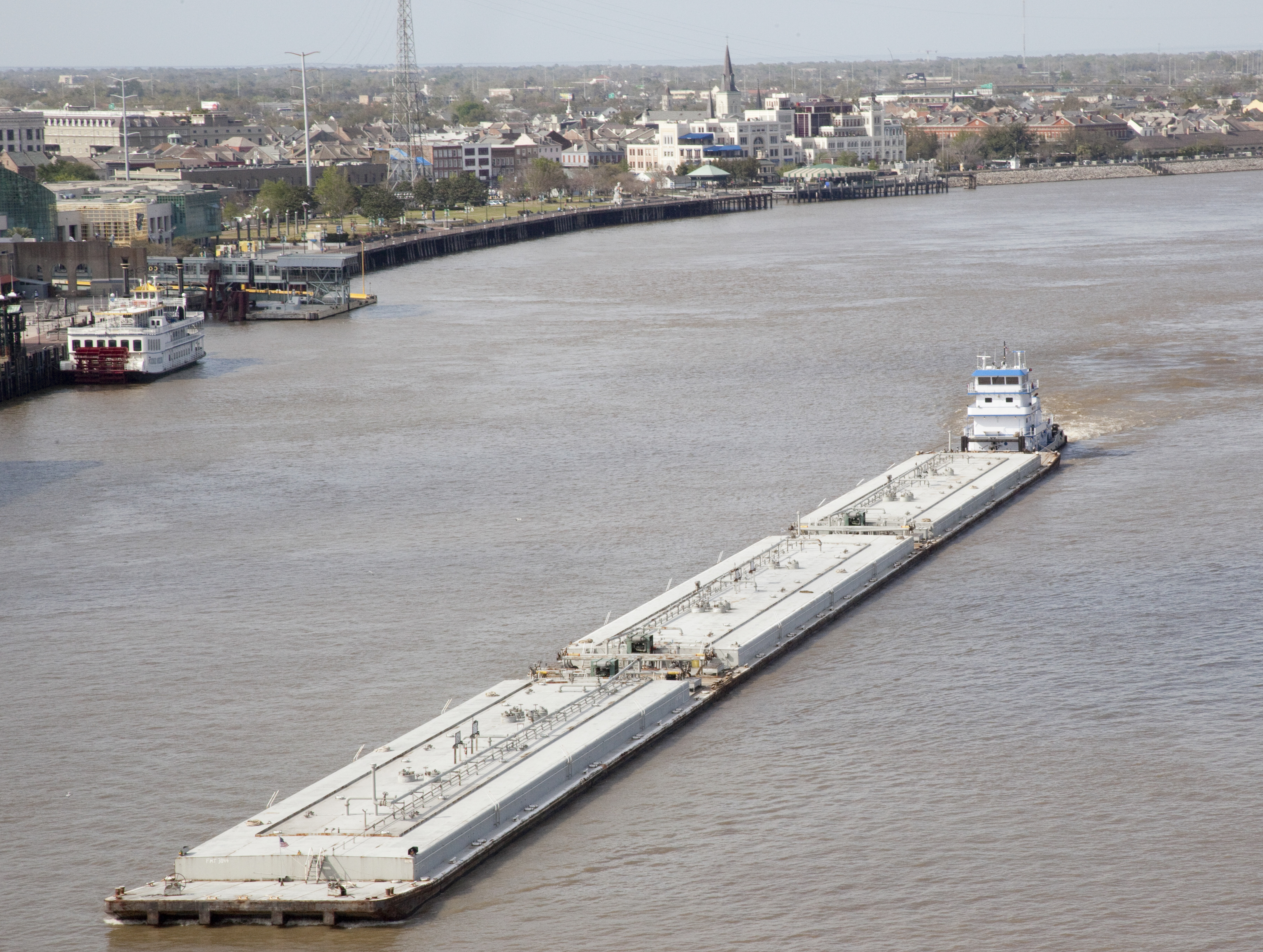 Towboat pushing barge by the French Quarter