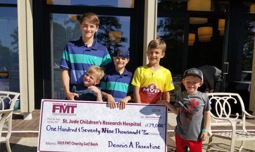 Children holding up check for St. Judge Children's Research Hospital at 2019 Annual Gold Tournament Fundraiser