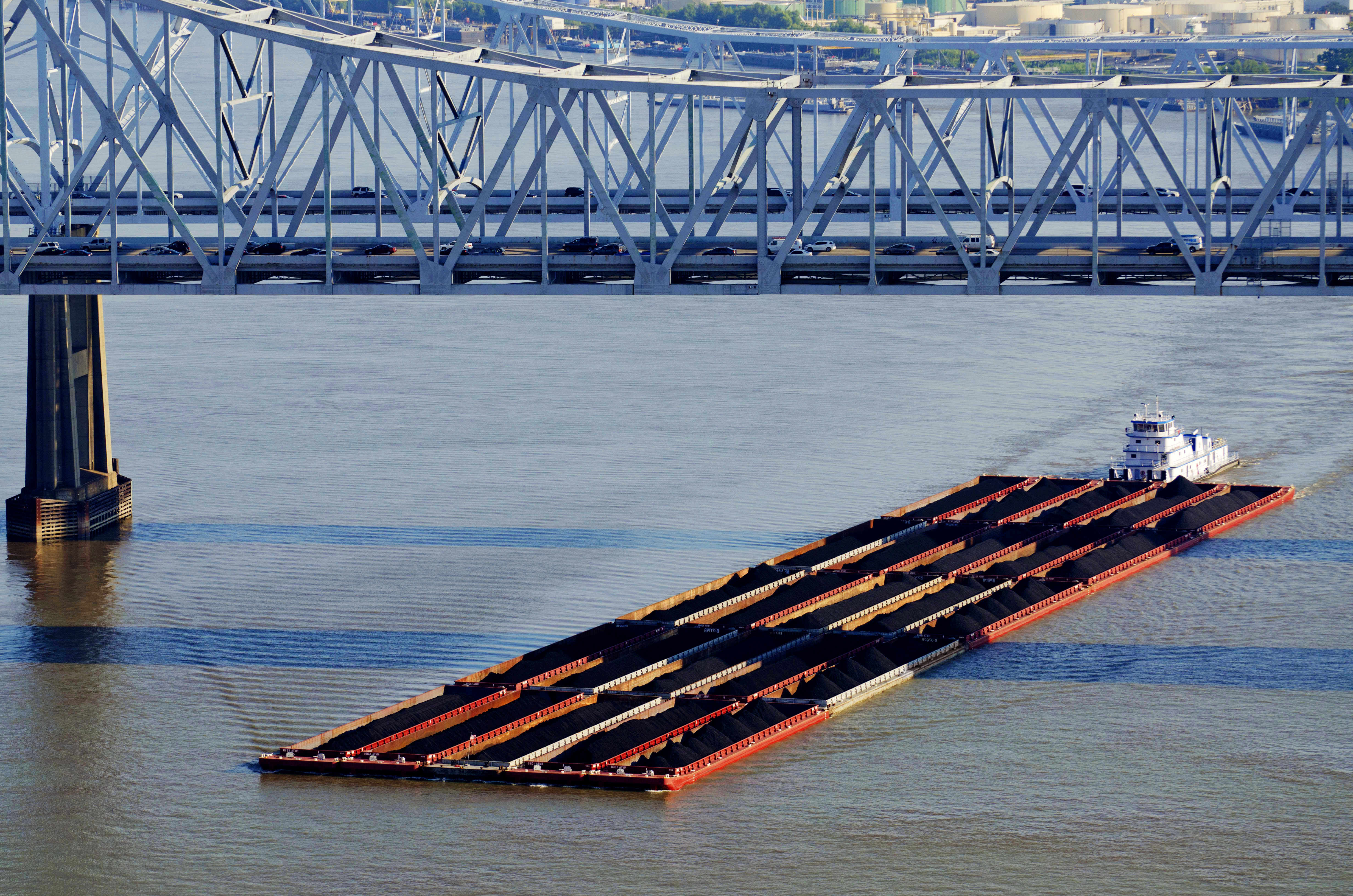 Florida Marine Transporters towboat transporting dry cargo heading under a bridge